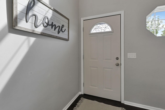 226 Purple Finch Loop, Pataskala, OH 43062 - doorway to outside featuring baseboards, healthy amount of natural light, and dark wood-style flooring