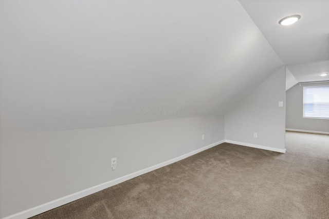 2538 Lexington Ave, Columbus, OH 43211 - additional living space featuring vaulted ceiling, dark carpet, and baseboards