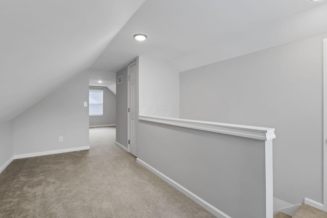 2538 Lexington Ave, Columbus, OH 43211 - additional living space with vaulted ceiling, carpet flooring, and baseboards