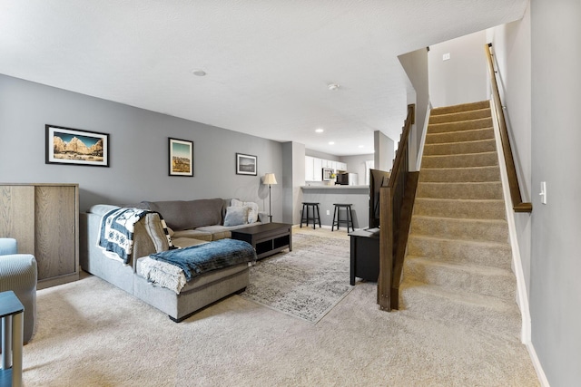 5290 Berthold Pass Dr, Dublin, OH 43016 - carpeted living room featuring stairway, baseboards, and recessed lighting