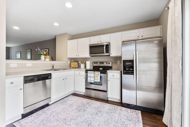 5290 Berthold Pass Dr, Dublin, OH 43016 - kitchen with stainless steel appliances, a sink, light countertops, white cabinets, and recessed lighting
