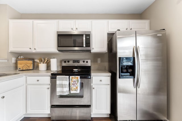 5290 Berthold Pass Dr, Dublin, OH 43016 - kitchen with stainless steel appliances, white cabinets, and light countertops