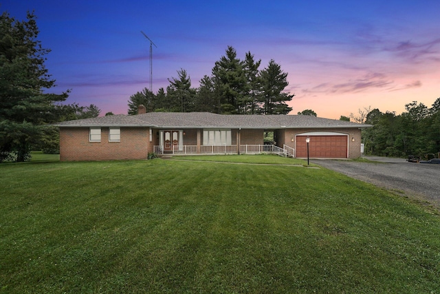 363 Carroll Eastern Rd NW, Baltimore, OH 43105 - ranch-style home featuring an attached garage, a yard, gravel driveway, a porch, and a chimney