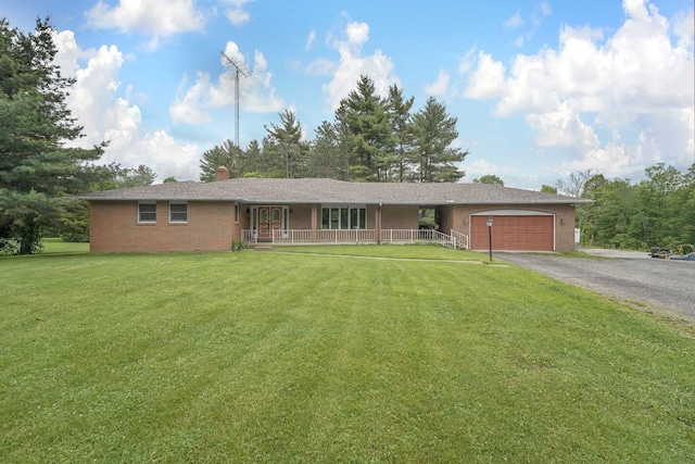363 Carroll Eastern Rd NW, Baltimore, OH 43105 - single story home featuring an attached garage, a porch, asphalt driveway, a front yard, and a chimney
