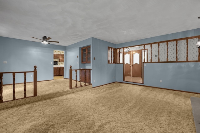 363 Carroll Eastern Rd NW, Baltimore, OH 43105 - unfurnished room with light colored carpet, baseboards, and ceiling fan
