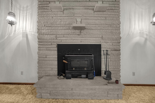 363 Carroll Eastern Rd NW, Baltimore, OH 43105 - detailed view of baseboards, carpet floors, and a wood stove