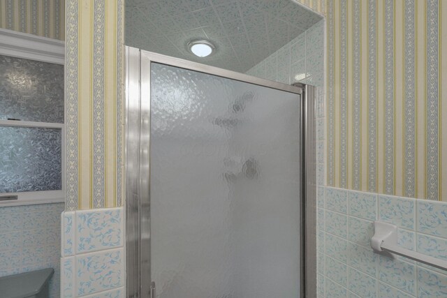 363 Carroll Eastern Rd NW, Baltimore, OH 43105 - bathroom featuring a stall shower and wallpapered walls