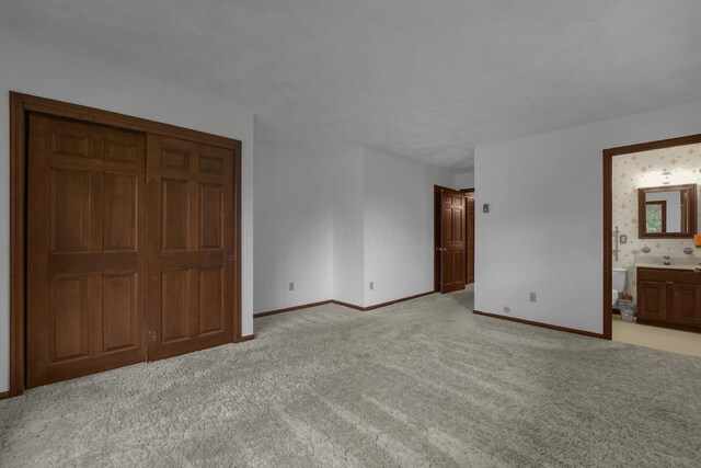 363 Carroll Eastern Rd NW, Baltimore, OH 43105 - unfurnished bedroom with light colored carpet, baseboards, and ensuite bathroom