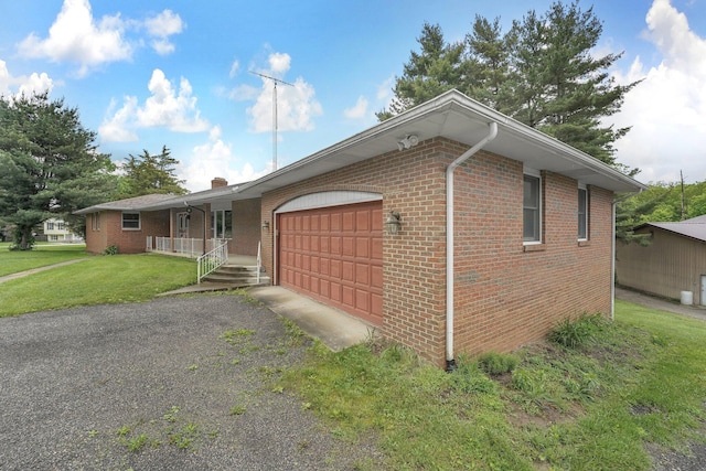 363 Carroll Eastern Rd NW, Baltimore, OH 43105 - view of front of home with covered porch, a garage, brick siding, and a front yard