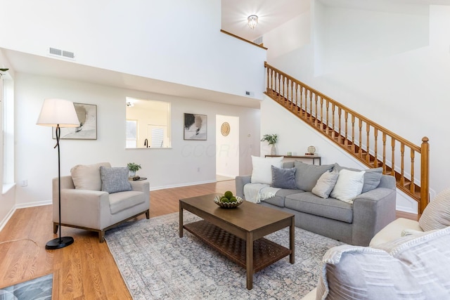 6641 Steen St, Canal Winchester, OH 43110 - living area featuring a towering ceiling, light wood-style flooring, and stairway