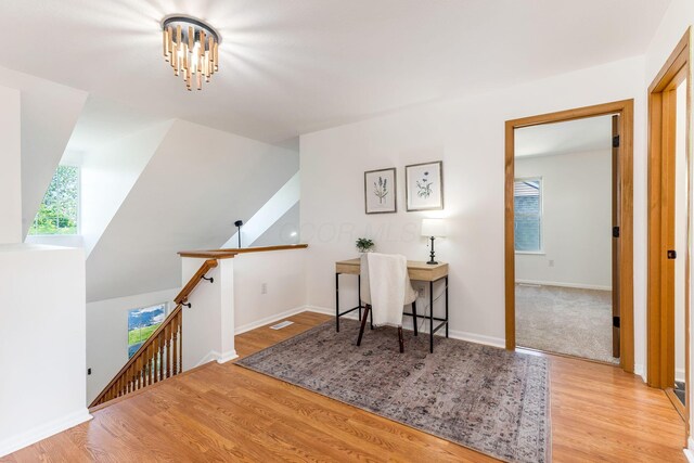 6641 Steen St, Canal Winchester, OH 43110 - living area with an upstairs landing, wood finished floors, and a chandelier