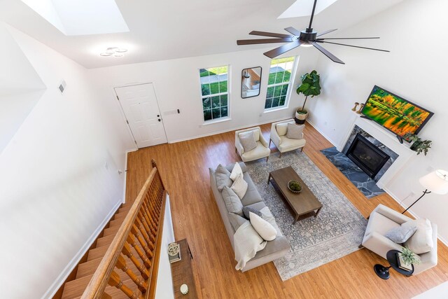 6641 Steen St, Canal Winchester, OH 43110 - living room with a glass covered fireplace, wood finished floors, a skylight, and a ceiling fan