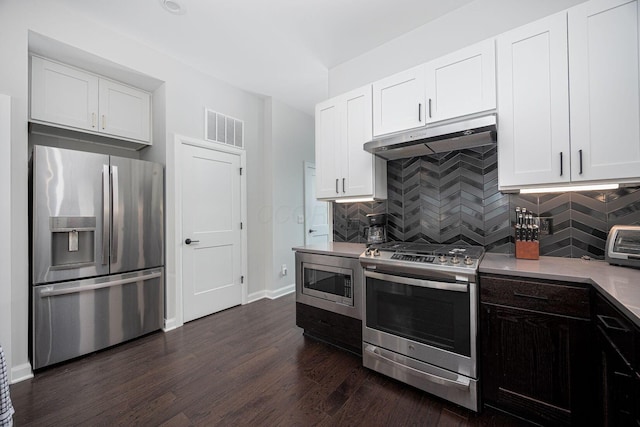 199 E 5th Ave, Columbus, OH 43201 - kitchen with appliances with stainless steel finishes, under cabinet range hood, dark wood-style floors, backsplash, and baseboards
