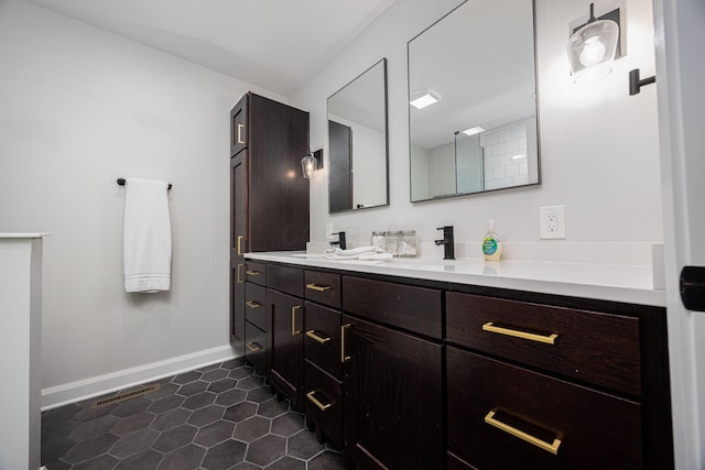 199 E 5th Ave, Columbus, OH 43201 - full bathroom with baseboards, double vanity, and tile patterned flooring