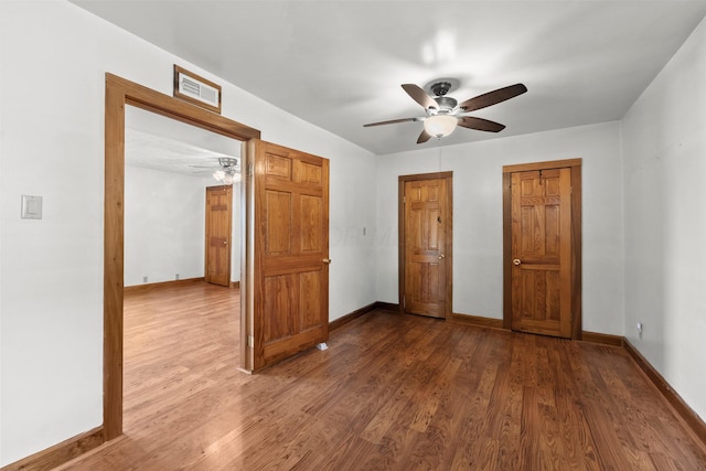 11007 Hebron Rd, Buckeye Lake, OH 43008 - unfurnished bedroom featuring wood finished floors, baseboards, and ceiling fan
