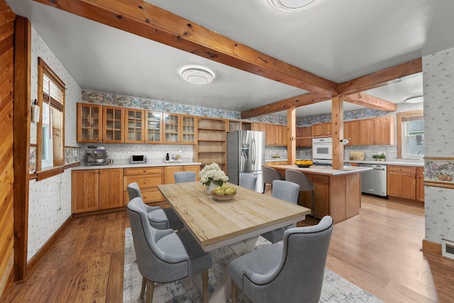 11007 Hebron Rd, Buckeye Lake, OH 43008 - kitchen with appliances with stainless steel finishes, wallpapered walls, light wood-type flooring, light countertops, and tasteful backsplash