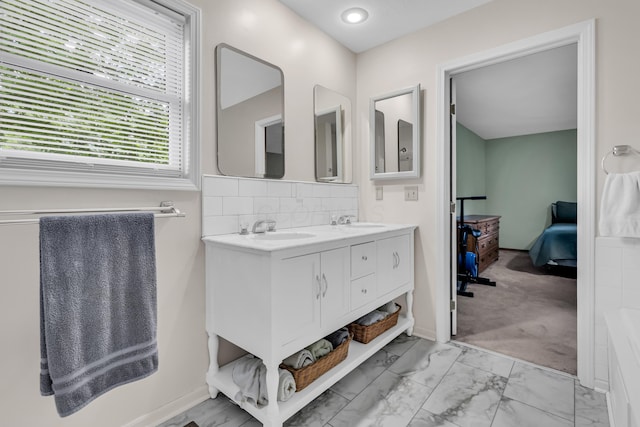 3753 Homer Rd NW, Utica, OH 43080 - bathroom featuring double vanity, connected bathroom, marble finish floors, and tasteful backsplash