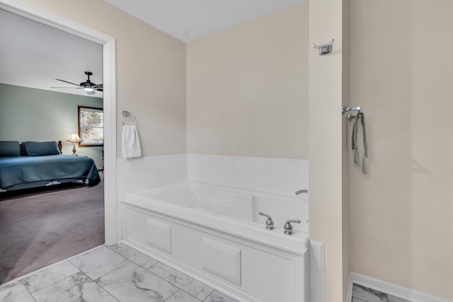 3753 Homer Rd NW, Utica, OH 43080 - bathroom with marble look tiles, ensuite bath, a garden tub, and ceiling fan