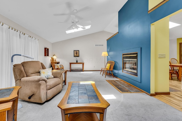 3753 Homer Rd NW, Utica, OH 43080 - living area featuring ceiling fan, a multi sided fireplace, a skylight, lofted ceiling, and carpet