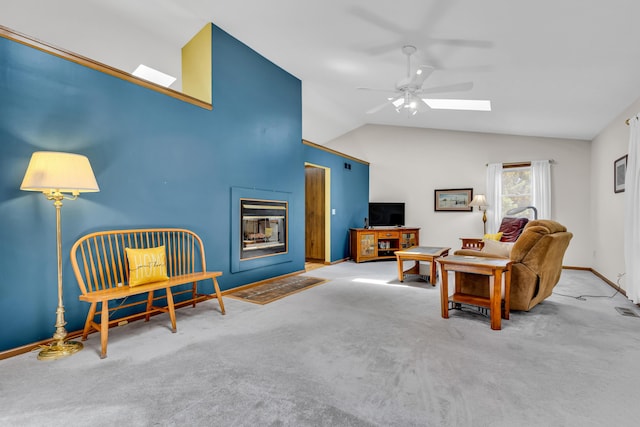 3753 Homer Rd NW, Utica, OH 43080 - carpeted living area featuring vaulted ceiling, ceiling fan, baseboards, a multi sided fireplace, and a skylight