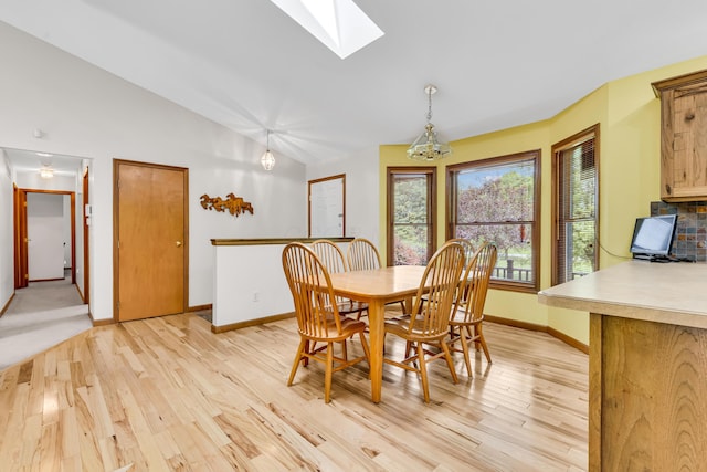 3753 Homer Rd NW, Utica, OH 43080 - dining room with baseboards, light wood-style floors, a skylight, and vaulted ceiling