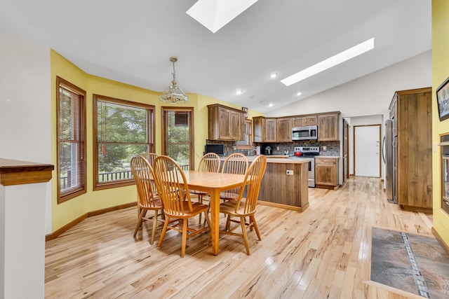 3753 Homer Rd NW, Utica, OH 43080 - dining area with a skylight, vaulted ceiling, light wood-style floors, recessed lighting, and baseboards