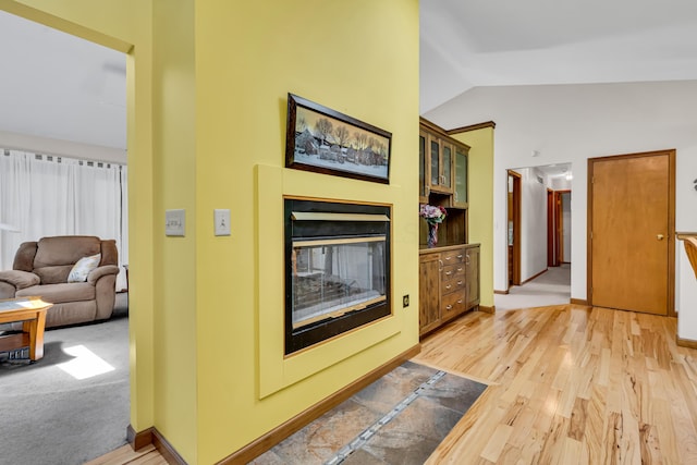 3753 Homer Rd NW, Utica, OH 43080 - living room featuring lofted ceiling, a multi sided fireplace, light wood-style flooring, and baseboards