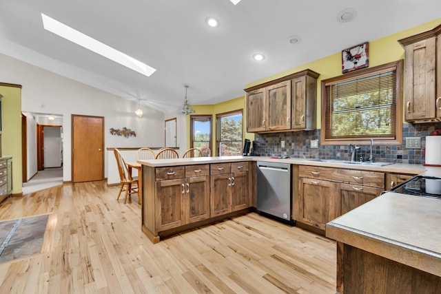 3753 Homer Rd NW, Utica, OH 43080 - kitchen with stainless steel dishwasher, a skylight, a peninsula, a sink, and backsplash