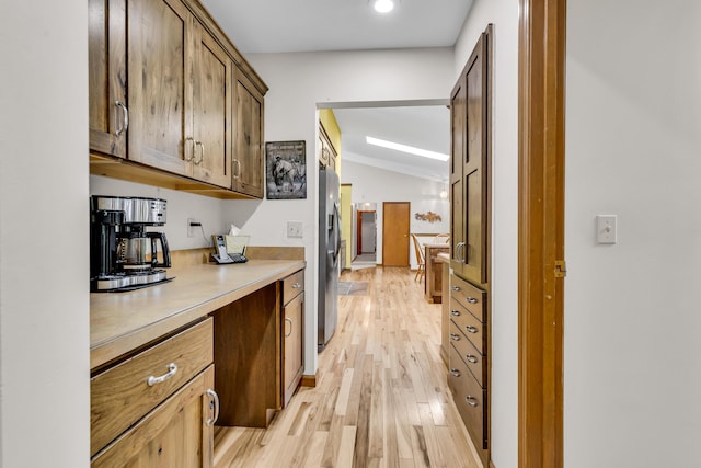 3753 Homer Rd NW, Utica, OH 43080 - bar featuring light wood-style floors, vaulted ceiling, stainless steel refrigerator with ice dispenser, and ornamental molding