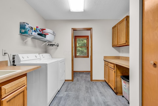 3753 Homer Rd NW, Utica, OH 43080 - laundry room featuring cabinet space, washer and clothes dryer, light wood-style floors, baseboards, and a textured ceiling