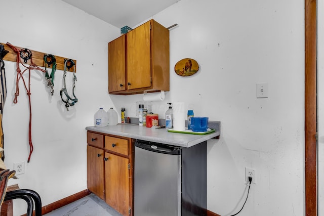 3753 Homer Rd NW, Utica, OH 43080 - kitchen featuring refrigerator, light countertops, brown cabinetry, concrete flooring, and baseboards
