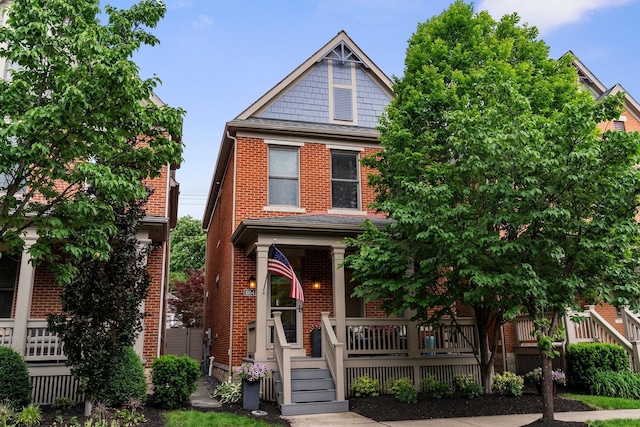 1054 Perry St, Columbus, OH 43201 - view of front of home featuring a porch and brick siding