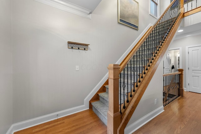 1054 Perry St, Columbus, OH 43201 - stairway with wood finished floors, ornamental molding, baseboards, and a towering ceiling