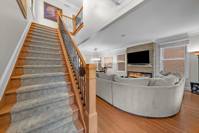 1054 Perry St, Columbus, OH 43201 - living room with crown molding, wood finished floors, stairway, and baseboards