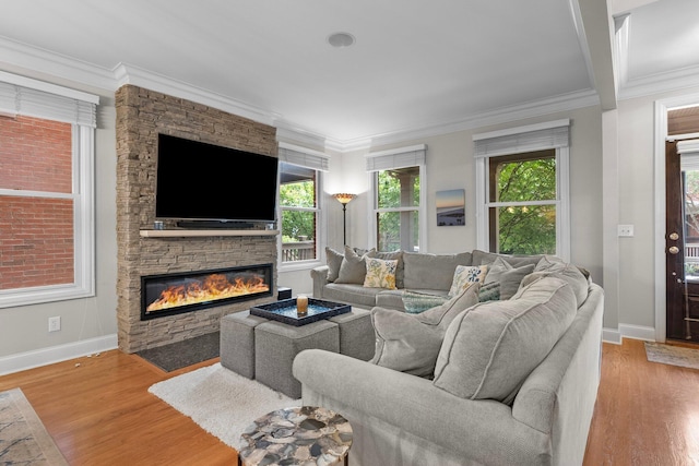 1054 Perry St, Columbus, OH 43201 - living area with a fireplace, light wood finished floors, baseboards, and crown molding