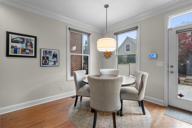 1054 Perry St, Columbus, OH 43201 - dining room with wood finished floors, baseboards, and crown molding