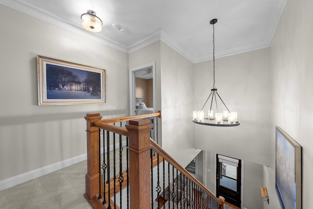 1054 Perry St, Columbus, OH 43201 - hallway with an upstairs landing, a chandelier, baseboards, ornamental molding, and carpet flooring
