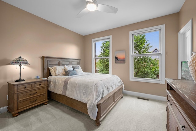 1054 Perry St, Columbus, OH 43201 - bedroom with baseboards, light colored carpet, and ceiling fan