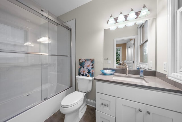 1054 Perry St, Columbus, OH 43201 - bathroom featuring vanity, toilet, and combined bath / shower with glass door