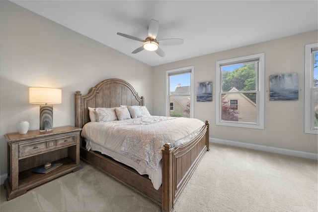 1054 Perry St, Columbus, OH 43201 - bedroom with light colored carpet, baseboards, lofted ceiling, and ceiling fan
