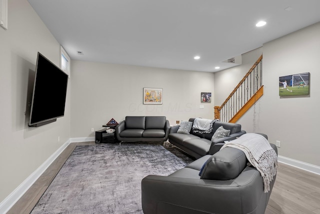 1054 Perry St, Columbus, OH 43201 - living room featuring wood finished floors, baseboards, recessed lighting, and stairway