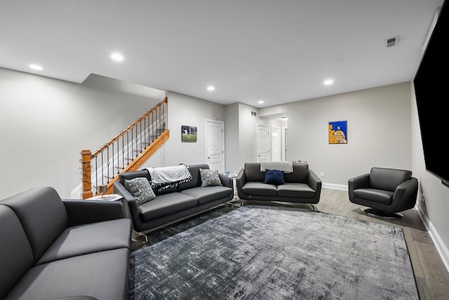 1054 Perry St, Columbus, OH 43201 - living area with wood finished floors, stairs, recessed lighting, and baseboards