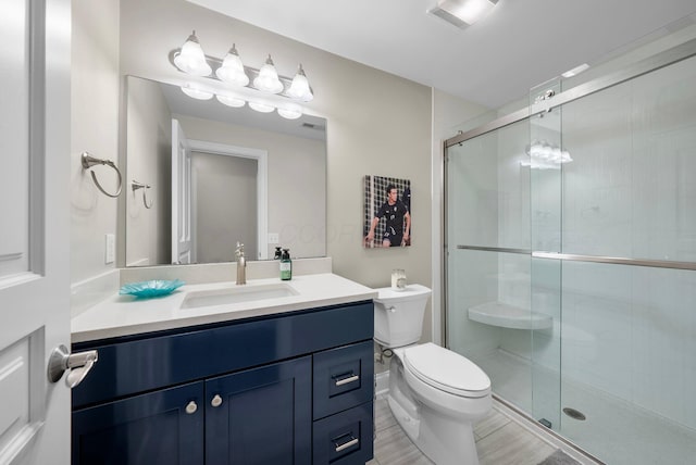 1054 Perry St, Columbus, OH 43201 - bathroom featuring toilet, vanity, and a shower stall