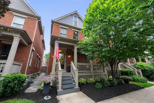 1054 Perry St, Columbus, OH 43201 - view of front of home with covered porch and brick siding