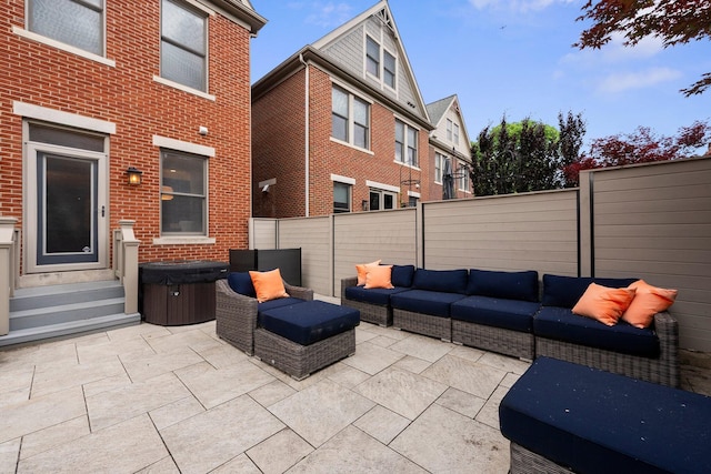 1054 Perry St, Columbus, OH 43201 - fenced backyard featuring an outdoor hangout area, a hot tub, a patio, and entry steps