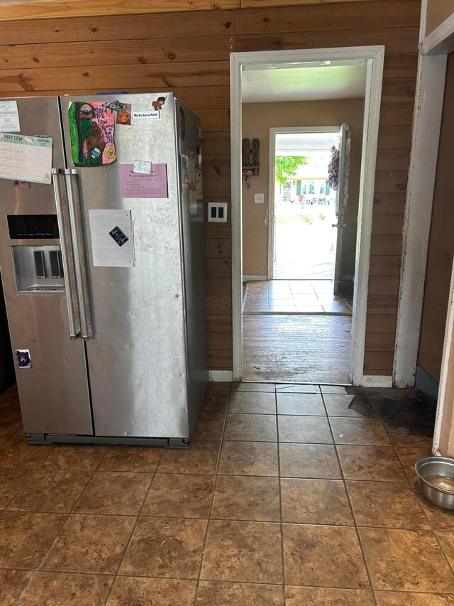 416 Reese Ave, Lancaster, OH 43130 - kitchen with stainless steel refrigerator with ice dispenser, wooden walls, and tile patterned flooring