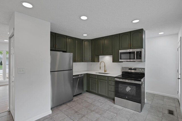 366 Orchard Ln, Sunbury, OH 43074 - kitchen featuring stainless steel appliances, green cabinetry, a sink, and recessed lighting