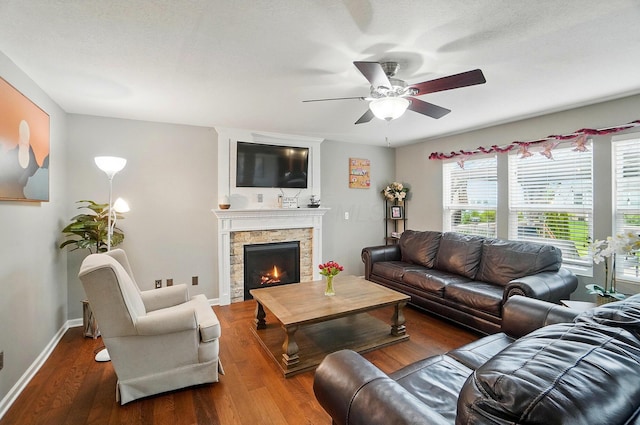 218 Christian St, Delaware, OH 43015 - living room featuring ceiling fan, wood finished floors, a fireplace, and baseboards