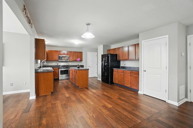 218 Christian St, Delaware, OH 43015 - kitchen with appliances with stainless steel finishes, dark countertops, baseboards, a sink, and brown cabinets