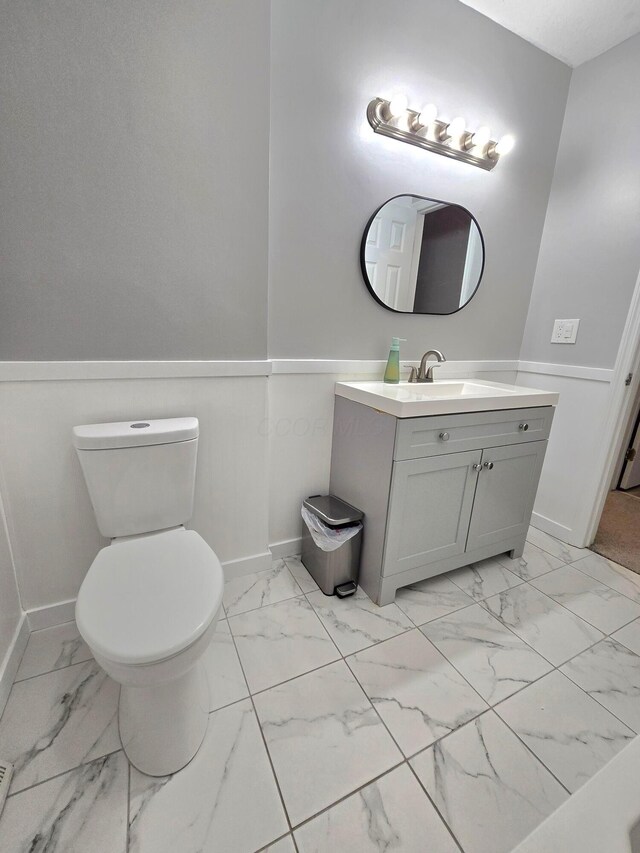 3523 Meldrake St, Columbus, OH 43230 - half bath with marble look tiles, baseboards, vanity, and toilet